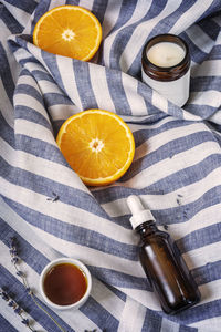 Composition with orange halves, oil, aroma candle, a bottle of sleep remedy. sleep care, relax