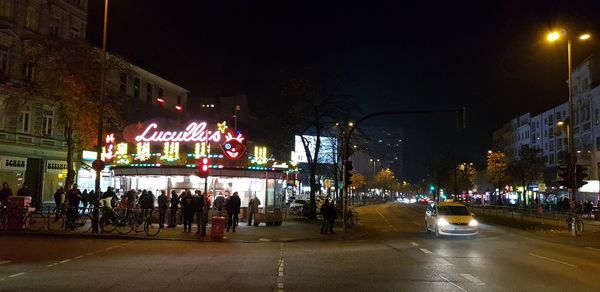 People on city street at night