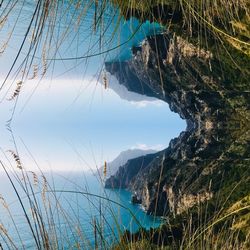 Scenic view of sea and mountains against sky