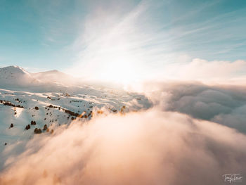 Aerial view of snowcapped mountains against sky