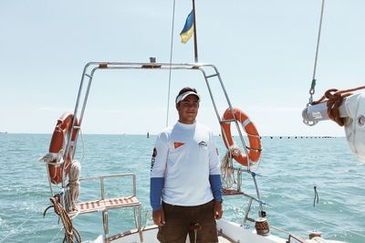 Portrait of man standing in sea against clear sky