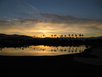 Scenic view of lake against sky during sunset