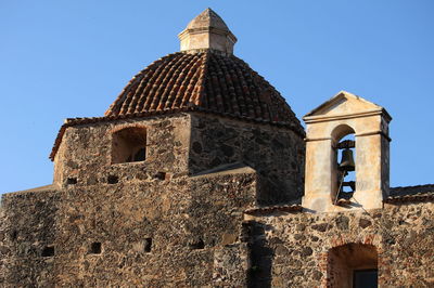 Low angle view of old building against blue sky