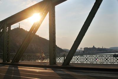 Sun shining through bridge