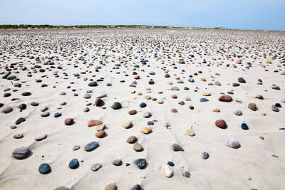 Aerial view of stones on beach against sky
