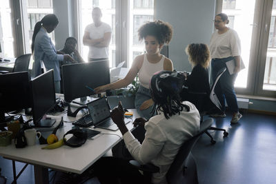 Multiracial male and female entrepreneurs working together at coworking office