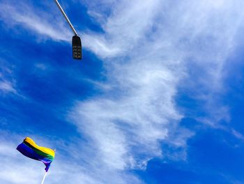 Low angle view of flag against blue sky