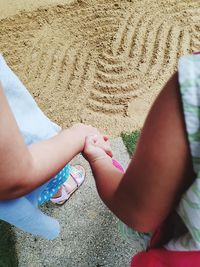 High angle view of couple holding hands
