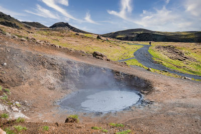 High angle view of geothermal mud spot amidst landscape in hveragerdi valley