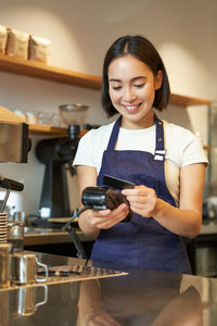 Portrait of young woman using mobile phone