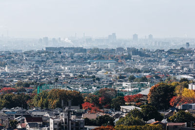 High angle view of buildings in city against sky