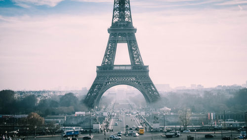 Eiffel tower during foggy weather against sky