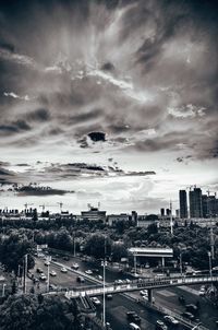 View of cityscape against cloudy sky