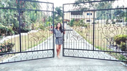 Woman standing by railing