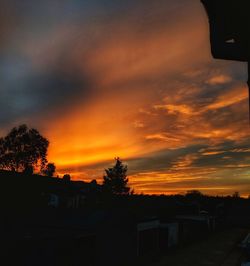 Silhouette buildings against sky during sunset