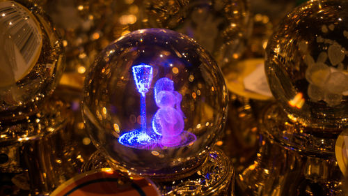 Close-up of illuminated lighting equipment on glass table