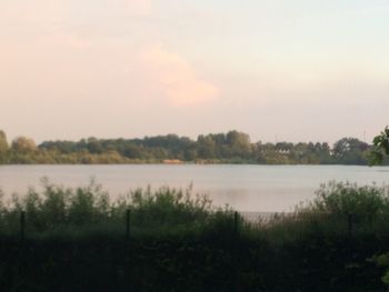 Scenic view of lake against sky during sunset