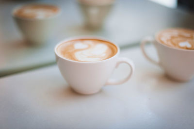 Coffee cups on table at cafe