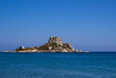 Scenic view of sea against clear blue sky