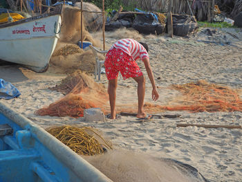 Rear view of men with umbrella on shore