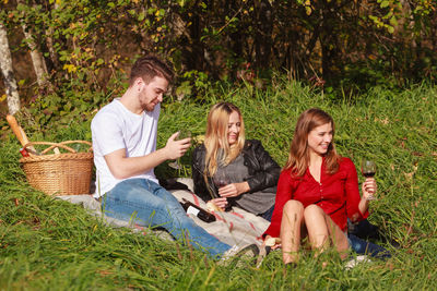 Man and women sitting on grass