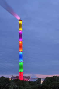 Illuminated building against blue sky at dusk