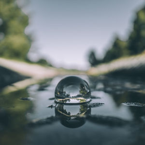 Close-up of water drop against sky