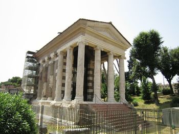 Gazebo in city against clear sky