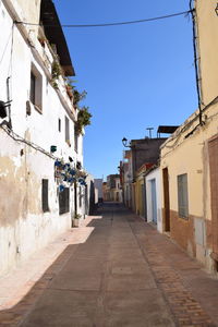 Empty alley amidst buildings in town