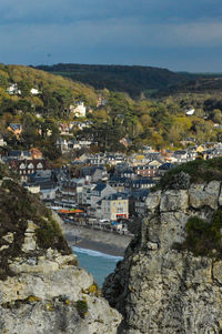 Scenic view of town by sea against sky