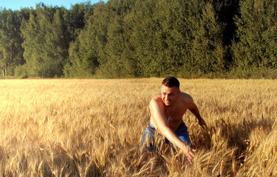 Rear view of woman standing on grassy field