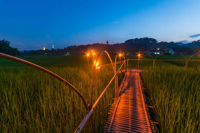 View of illuminated railing against blue sky