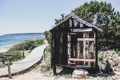 Built structure on beach against clear sky