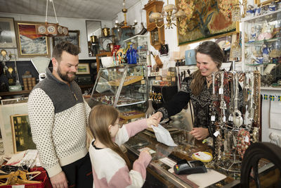 Father with daughter doing shopping in antique shop