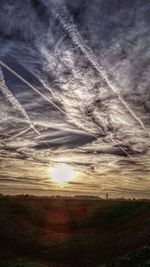 Scenic view of field against cloudy sky