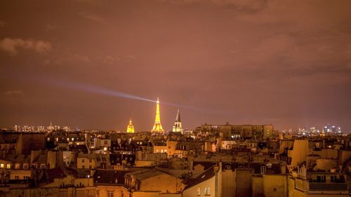 Illuminated cityscape against sky