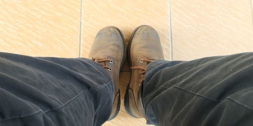 Low section of man against tiled floor