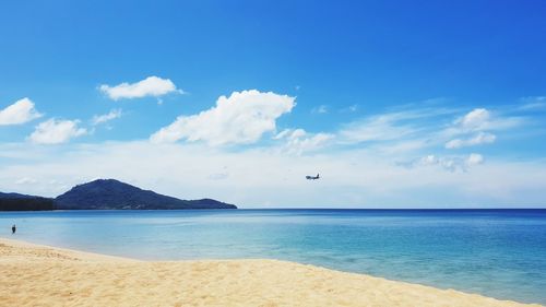 Scenic view of beach against blue sky