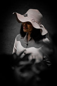 Selective focused portrait of a young girl wearing a hat walking on the street 