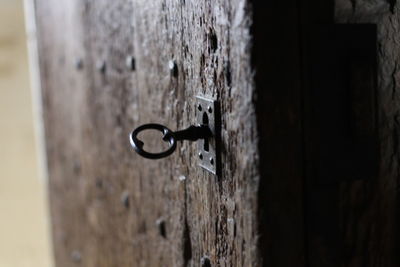 Close-up of key in lock on door