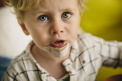 Portrait of little boy with patch on his chin