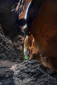 Rear view of woman standing on rock