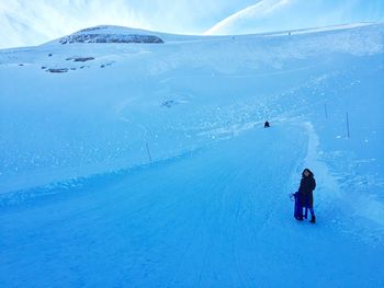 Girl standing on snow covered mountain