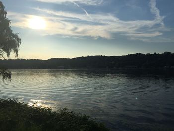 Scenic view of lake against sky at sunset