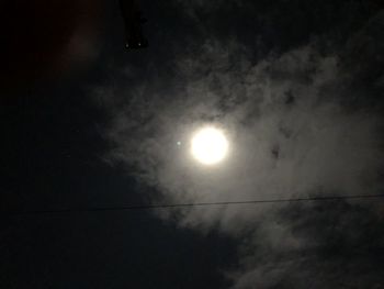 Low angle view of silhouette moon against sky at night