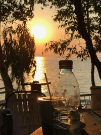 Close-up of beer on table at sunset