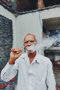 Portrait of man smoking cigarette