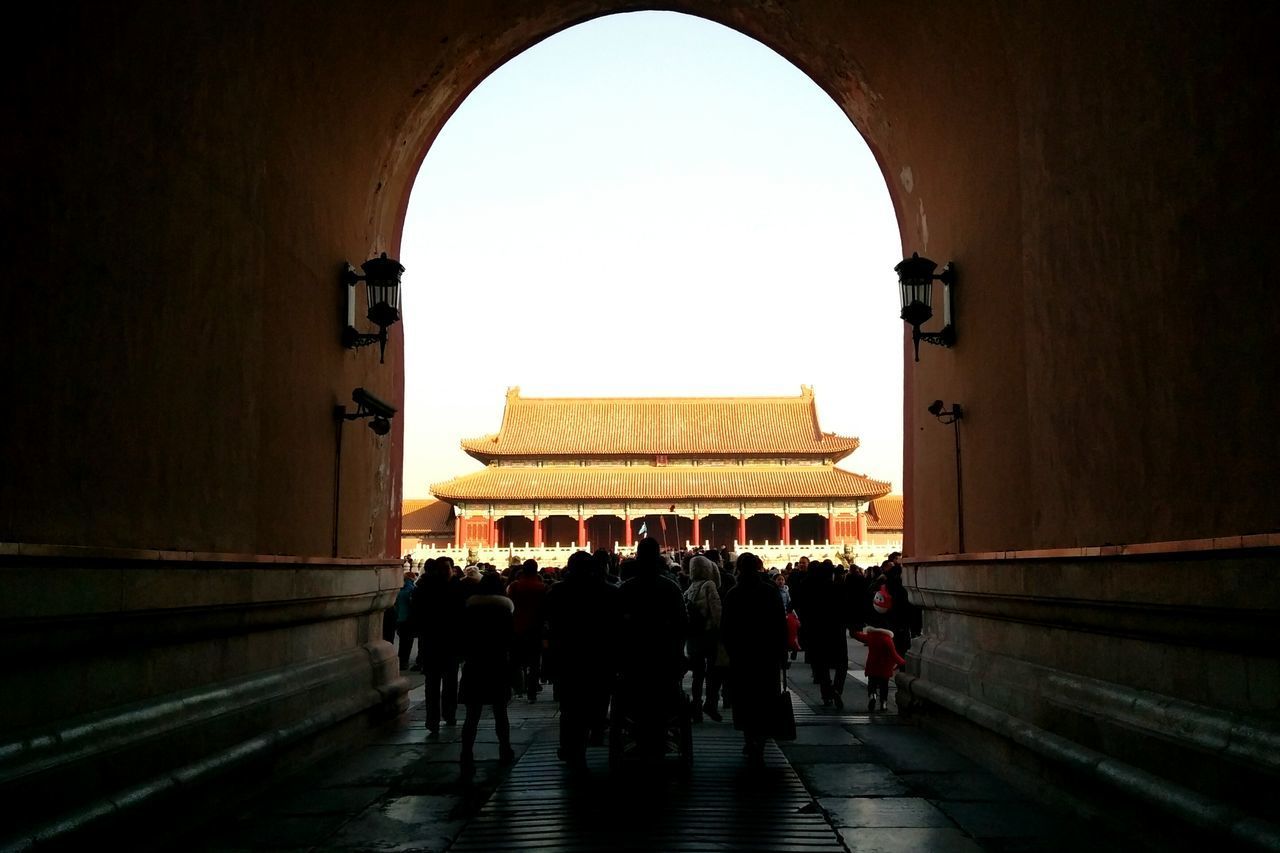 GROUP OF PEOPLE WALKING IN HISTORIC BUILDING