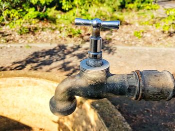 Close-up of water faucet against black background