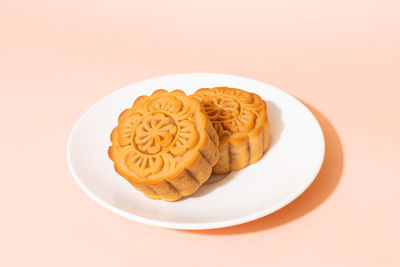 High angle view of food in plate on pink background